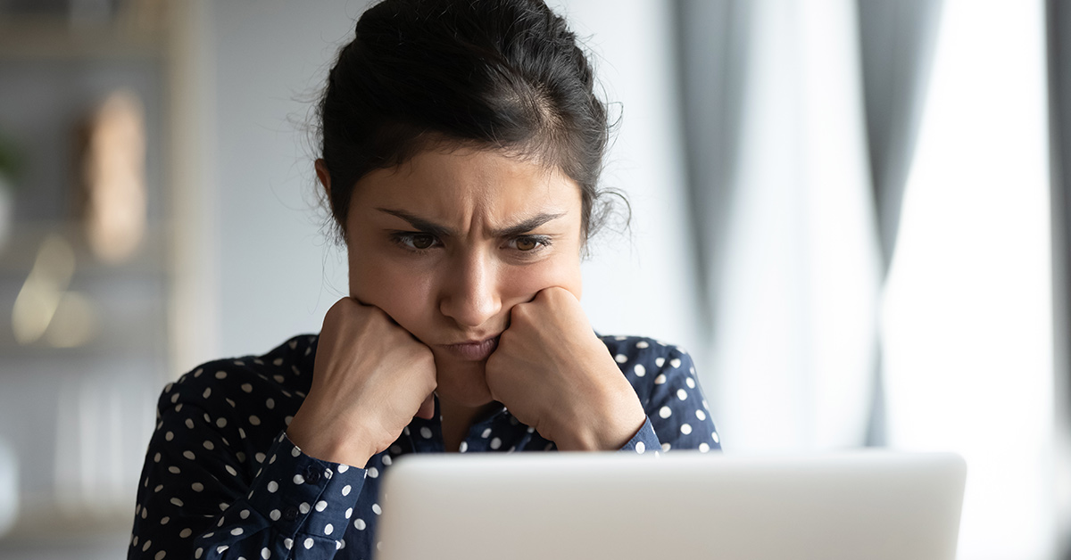 frustrated woman staring at a screen