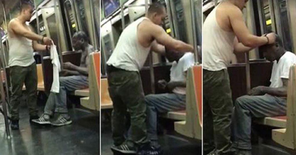 Joey Resto giving hist shirt to a homeless man on the new york subway