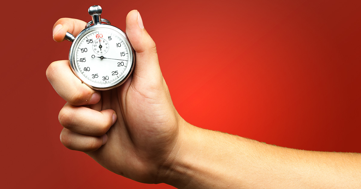 hand holding a stop watch with a red background