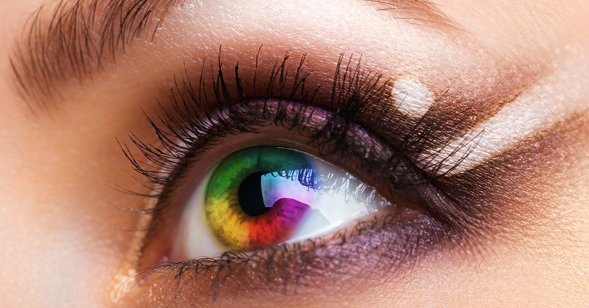 close of of an eye with a rainbow colored iris