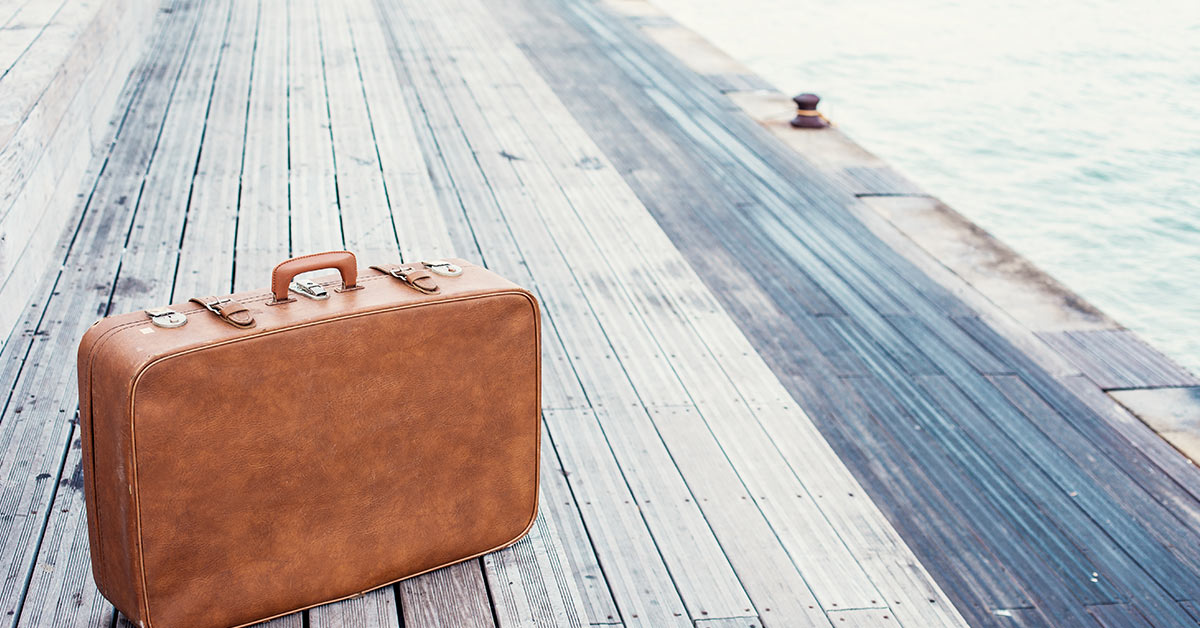 old suitcase sitting on a wooden dock