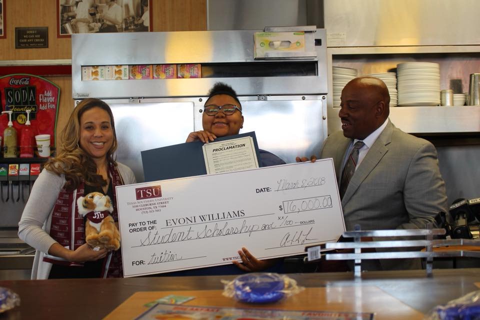 Evoni being presented with a scholarship at TSU.