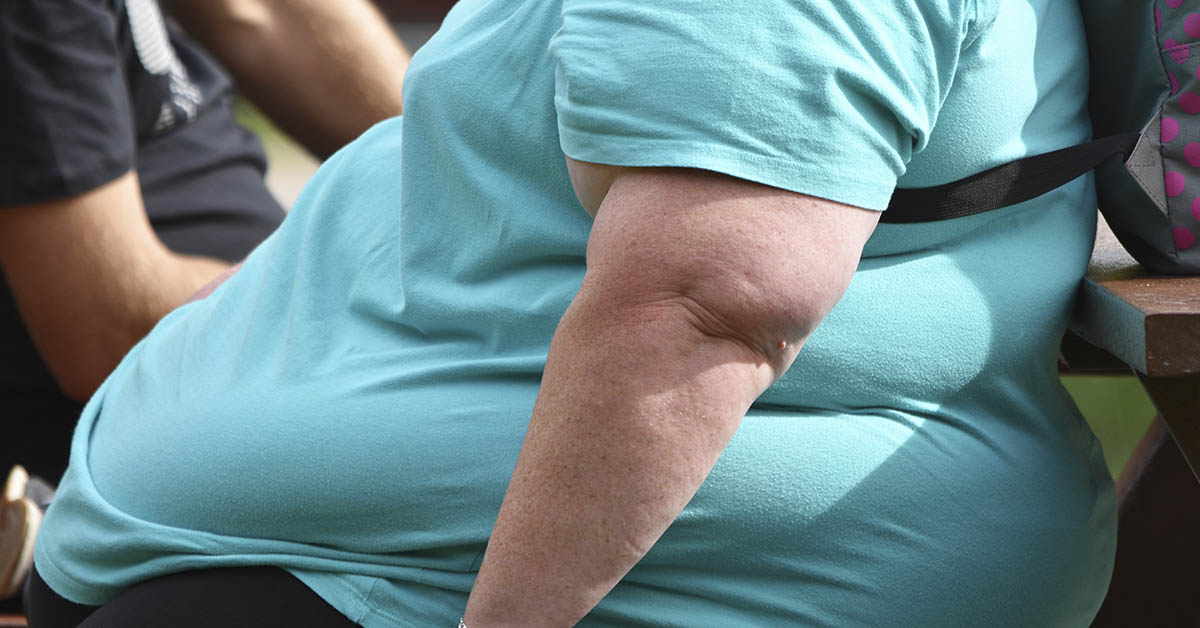 overweight person wearing a blue shirt