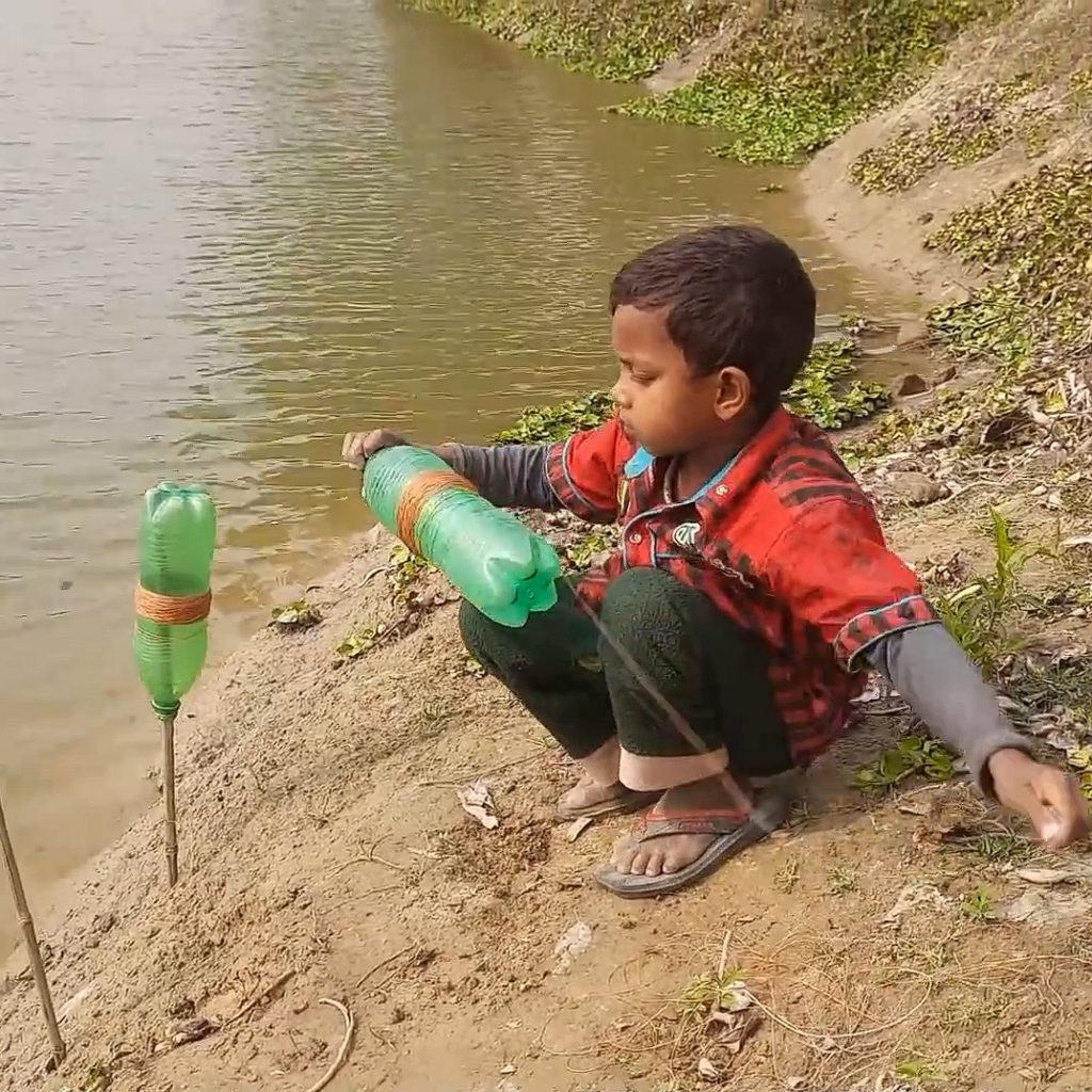 boy using plastic bottles as tools to fish